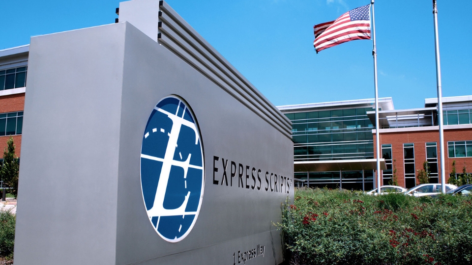 Express Scripts corporate headquarters with American flag flying against clear blue sky