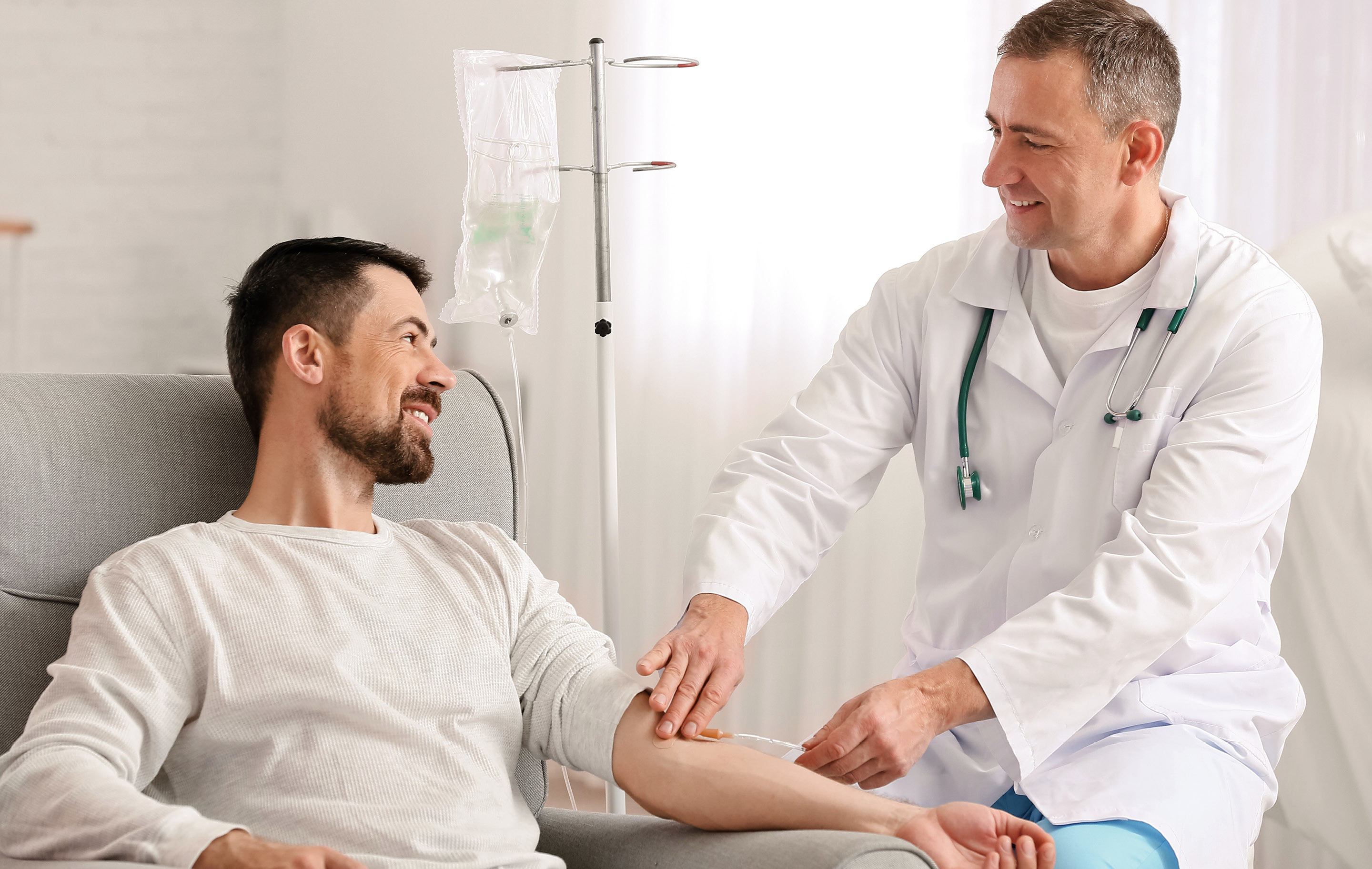 Doctor gently checks patient's pulse in bright hospital room