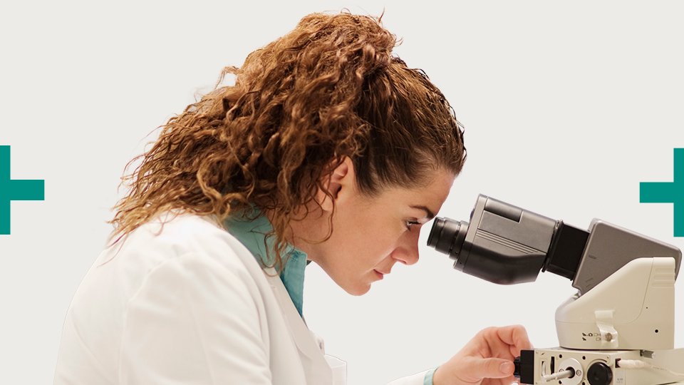 Woman looking through microscope