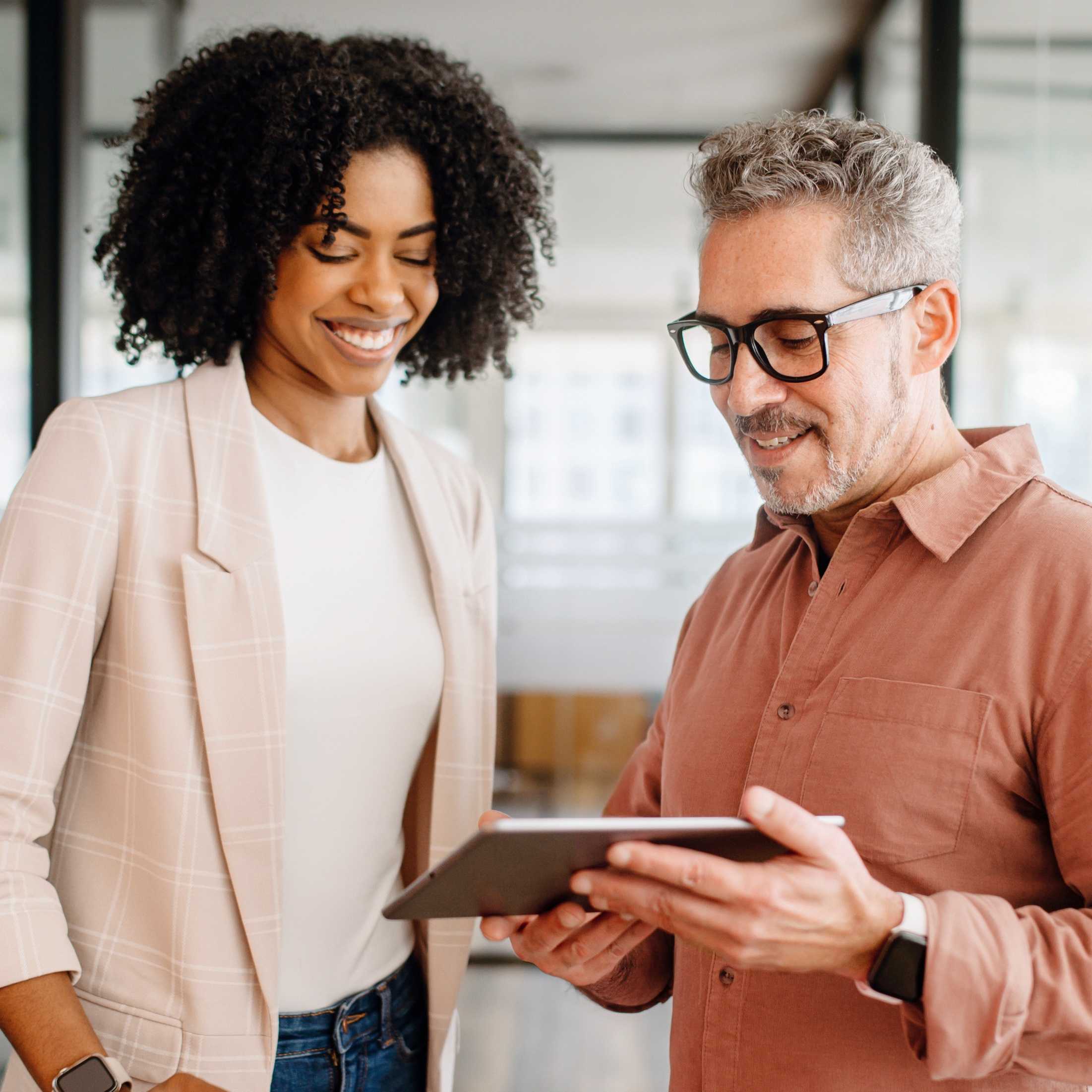 woman and man talking with tablet
