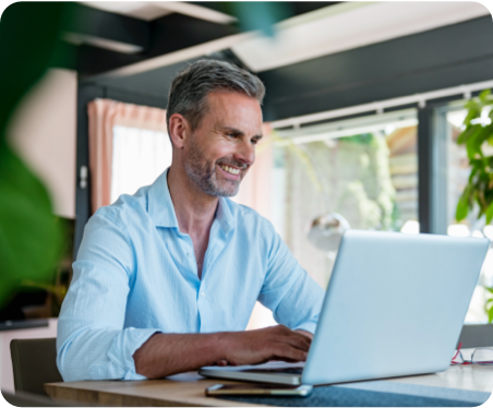 Man sitting at desk with laptop open