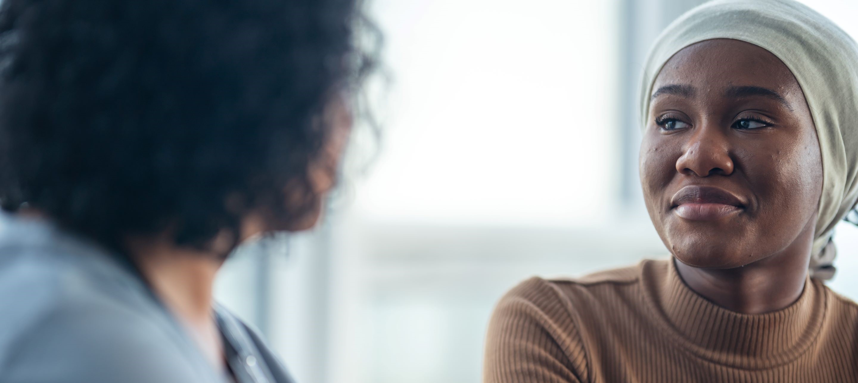 Woman with headscarf and beige sweater