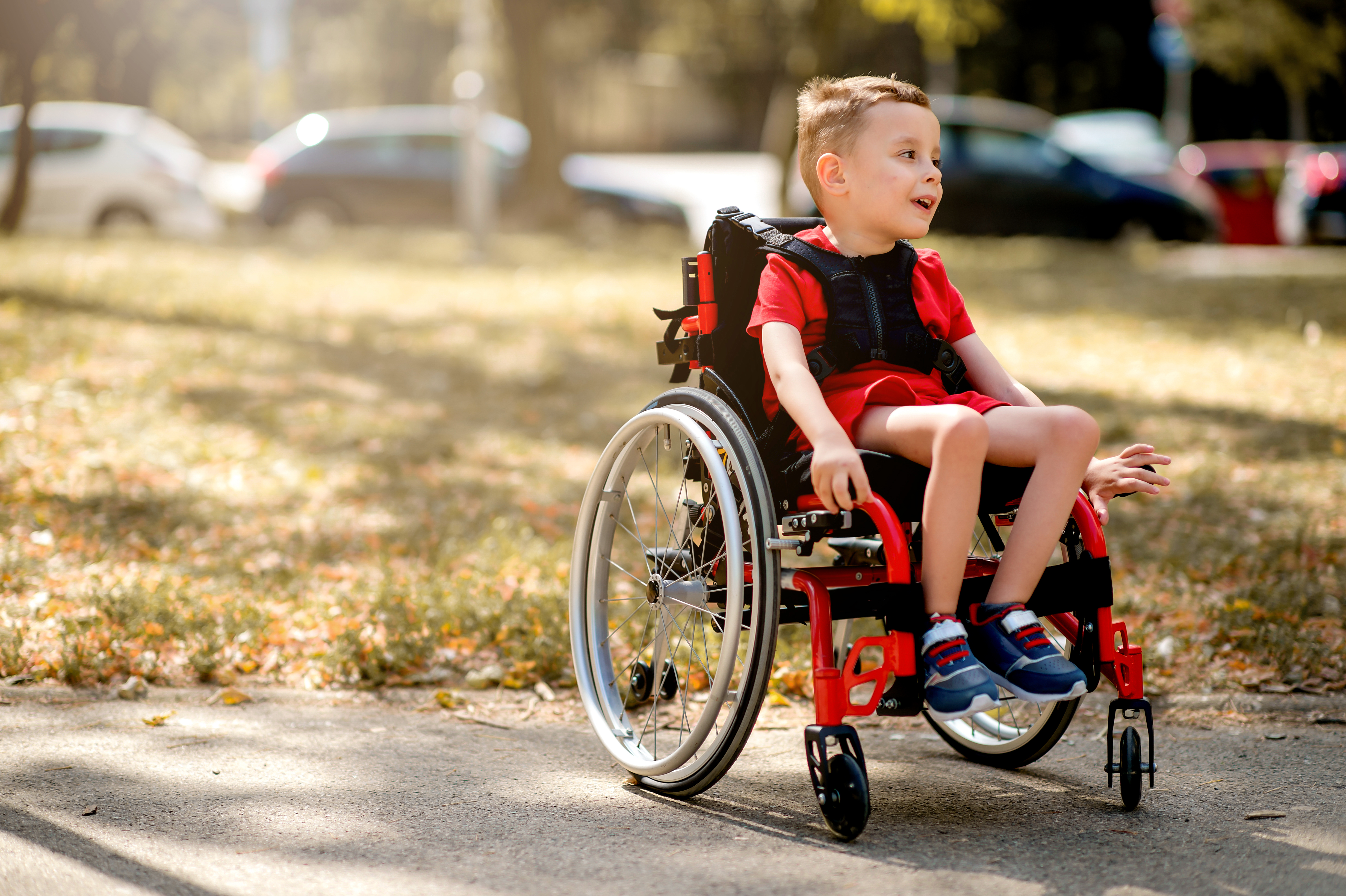 Young child in a wheelchair outside