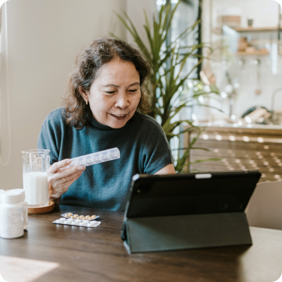 Woman holds weekly prescription organizer