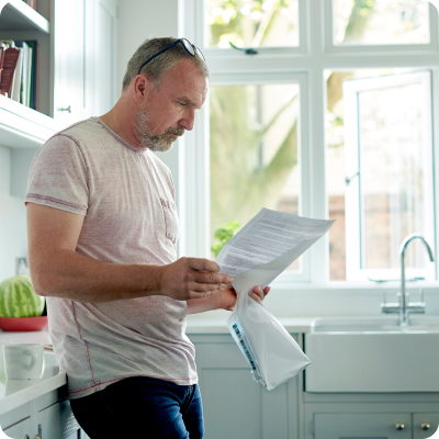 man reads in kitchen