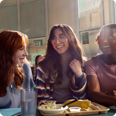 Girl at lunchroom with friends