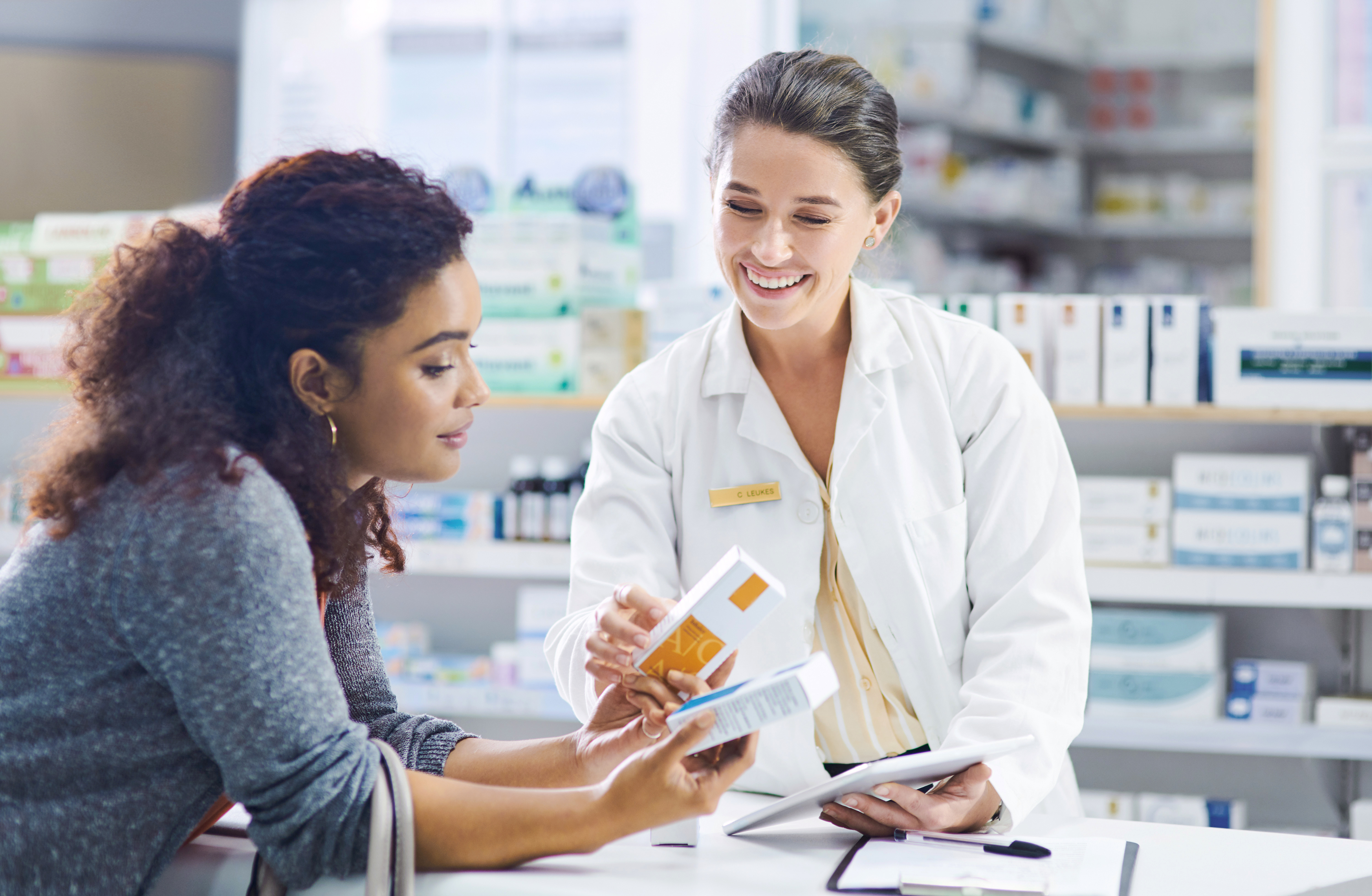 Woman consulting with Female Pharmacist