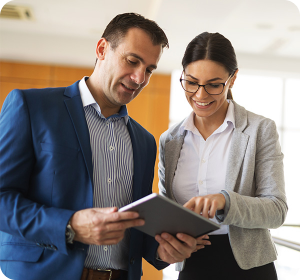 two colleagues looking down at a brochure