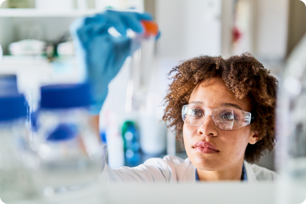 woman in lab holding tube
