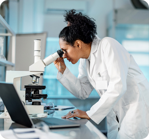 woman looking in microscope