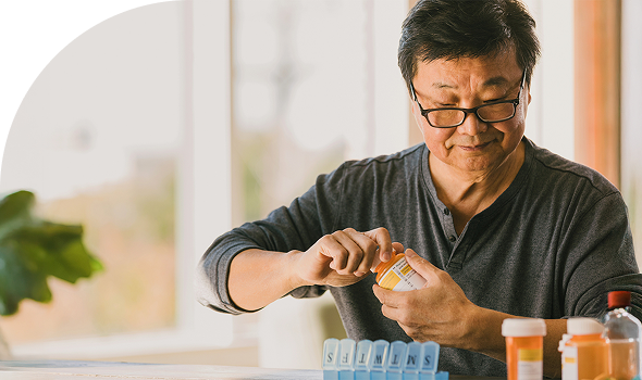 man with pill bottle