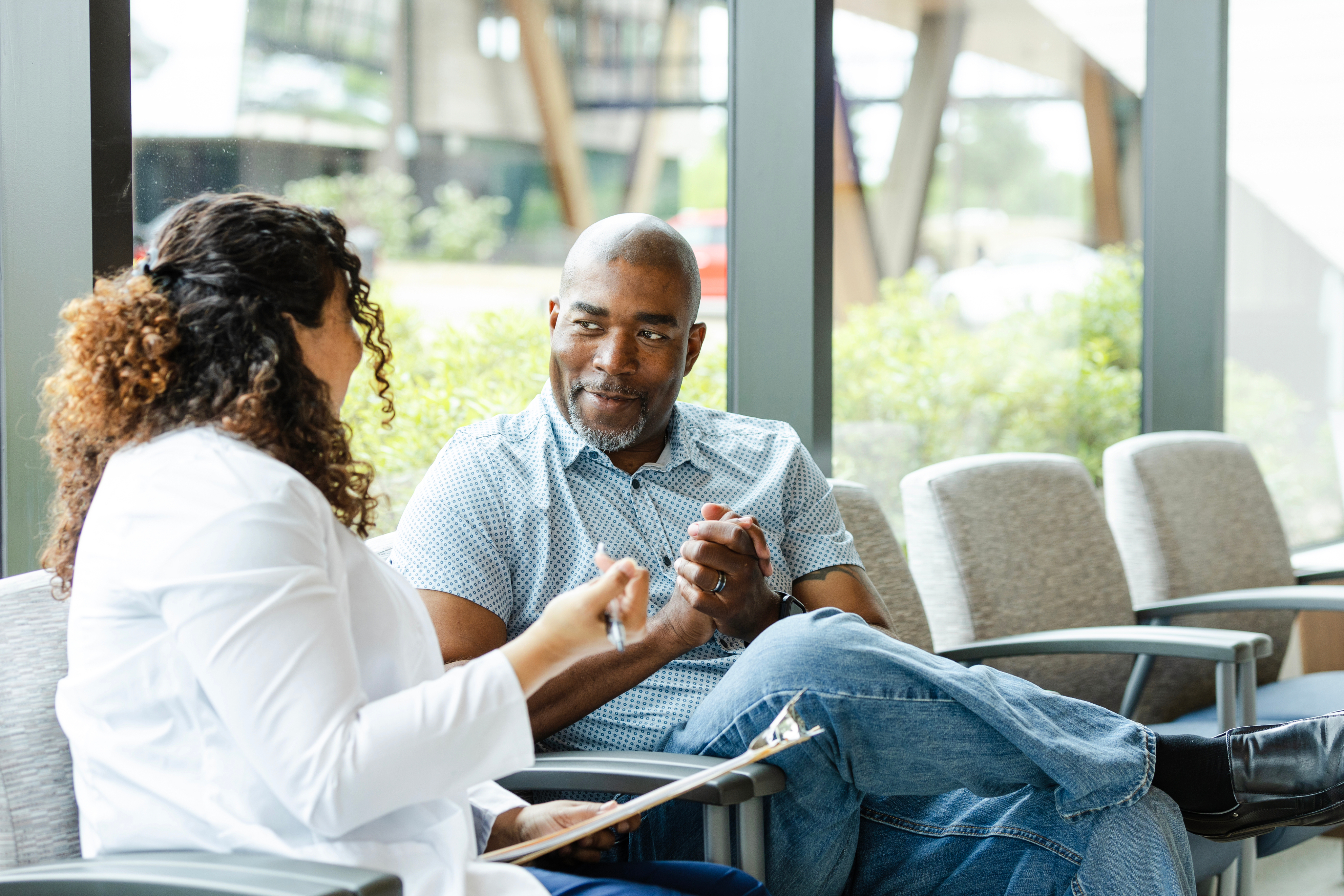 man talking with doctor in chair