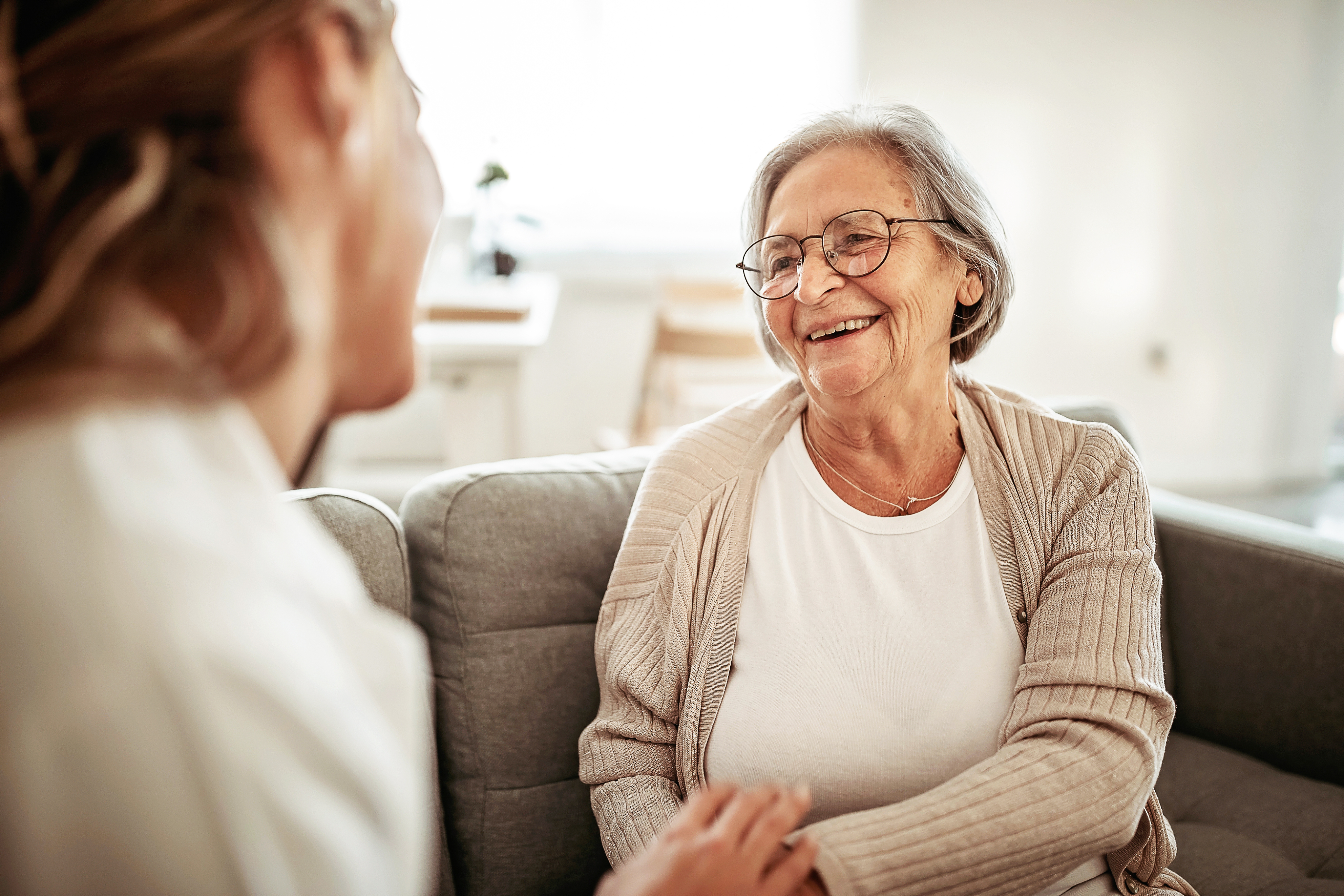 Provider sitting with elderly female patient