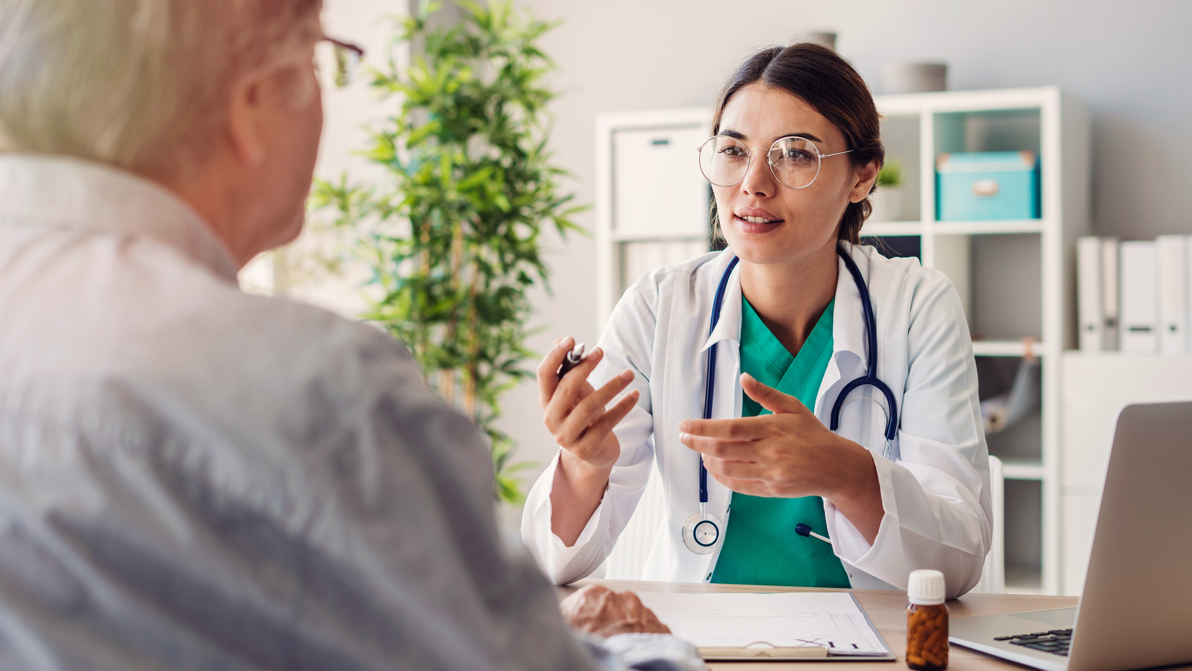 Doctor talking to patient at desk