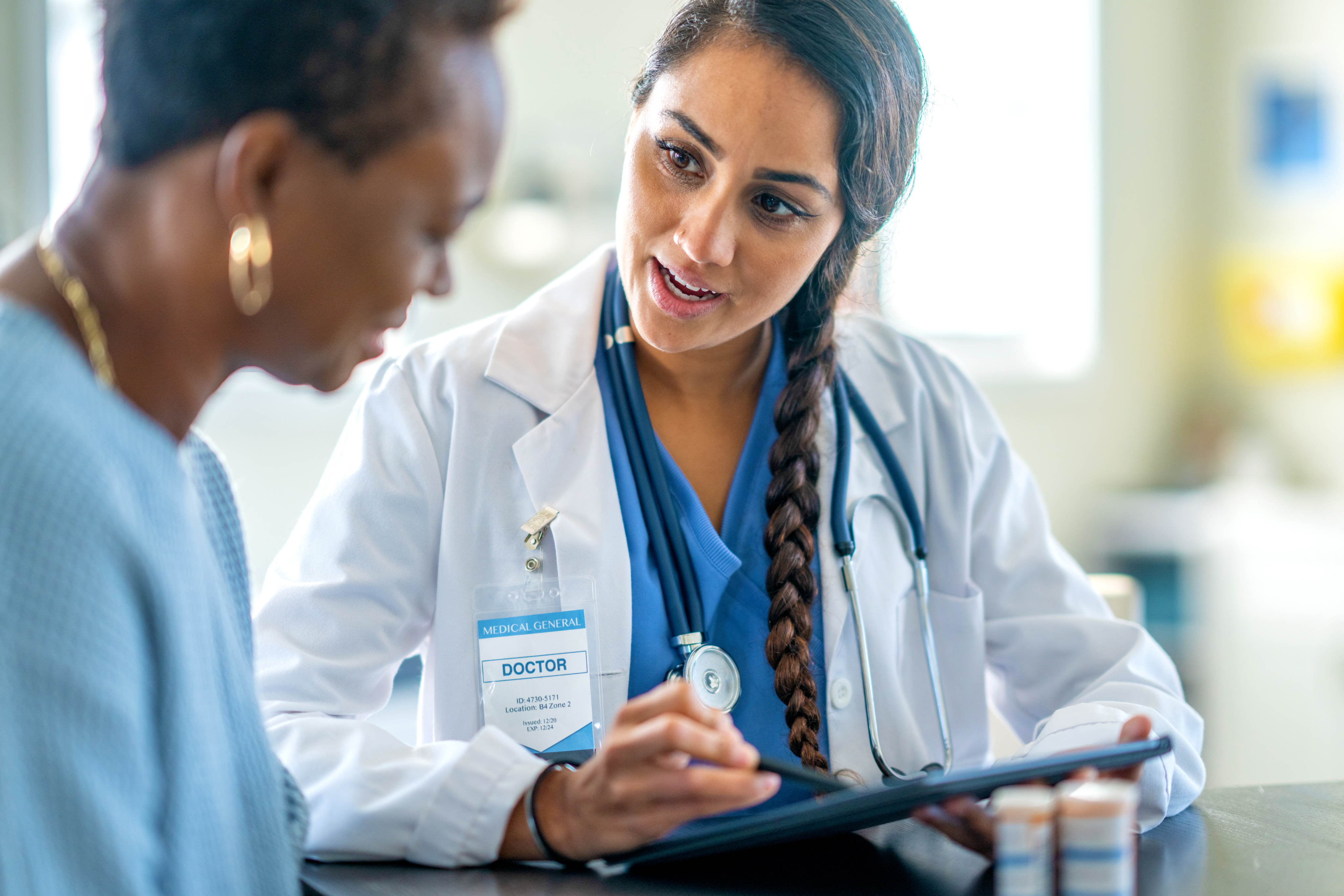 female doctor talking to female patient