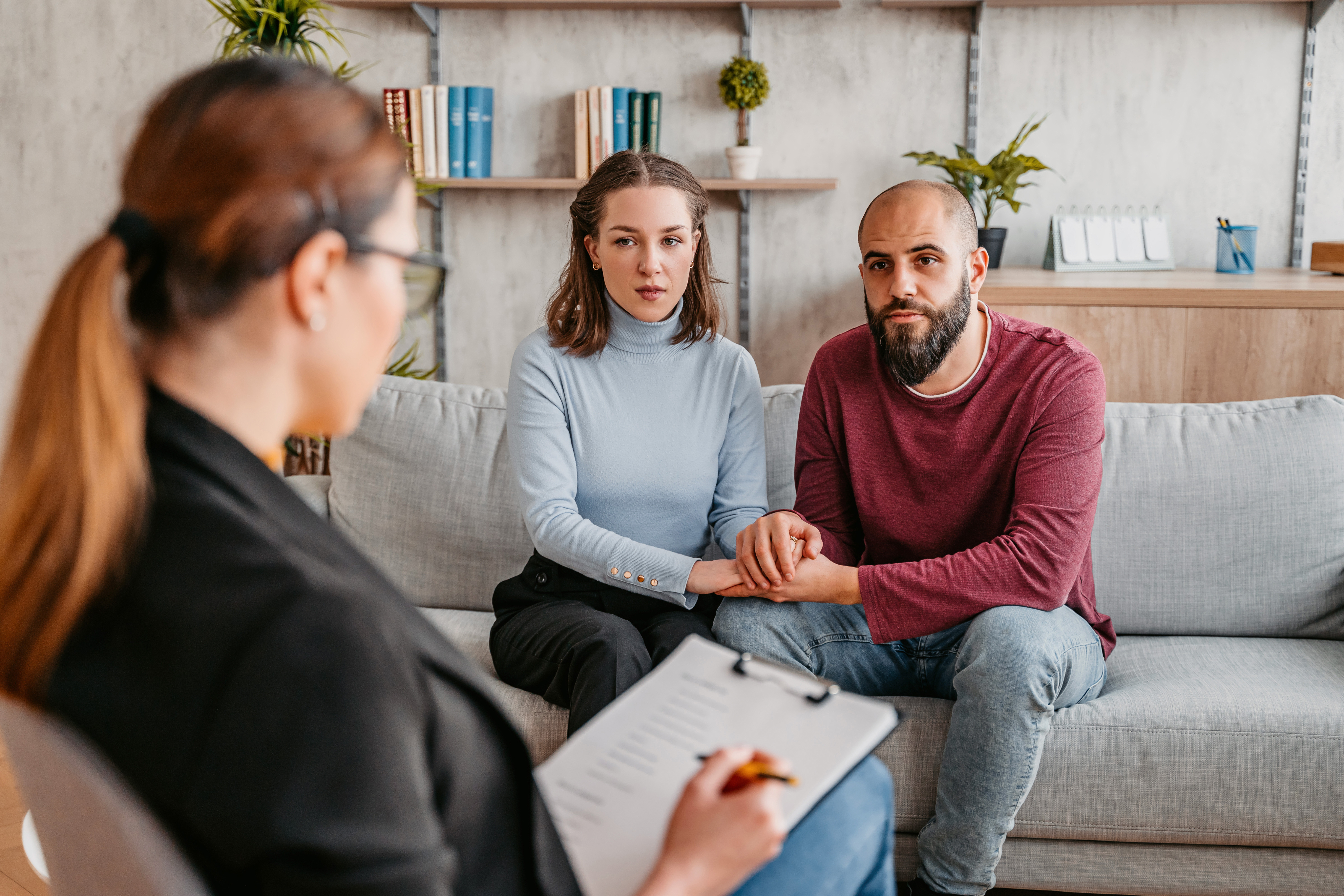 couple sitting on sofa taking to mental health specialist