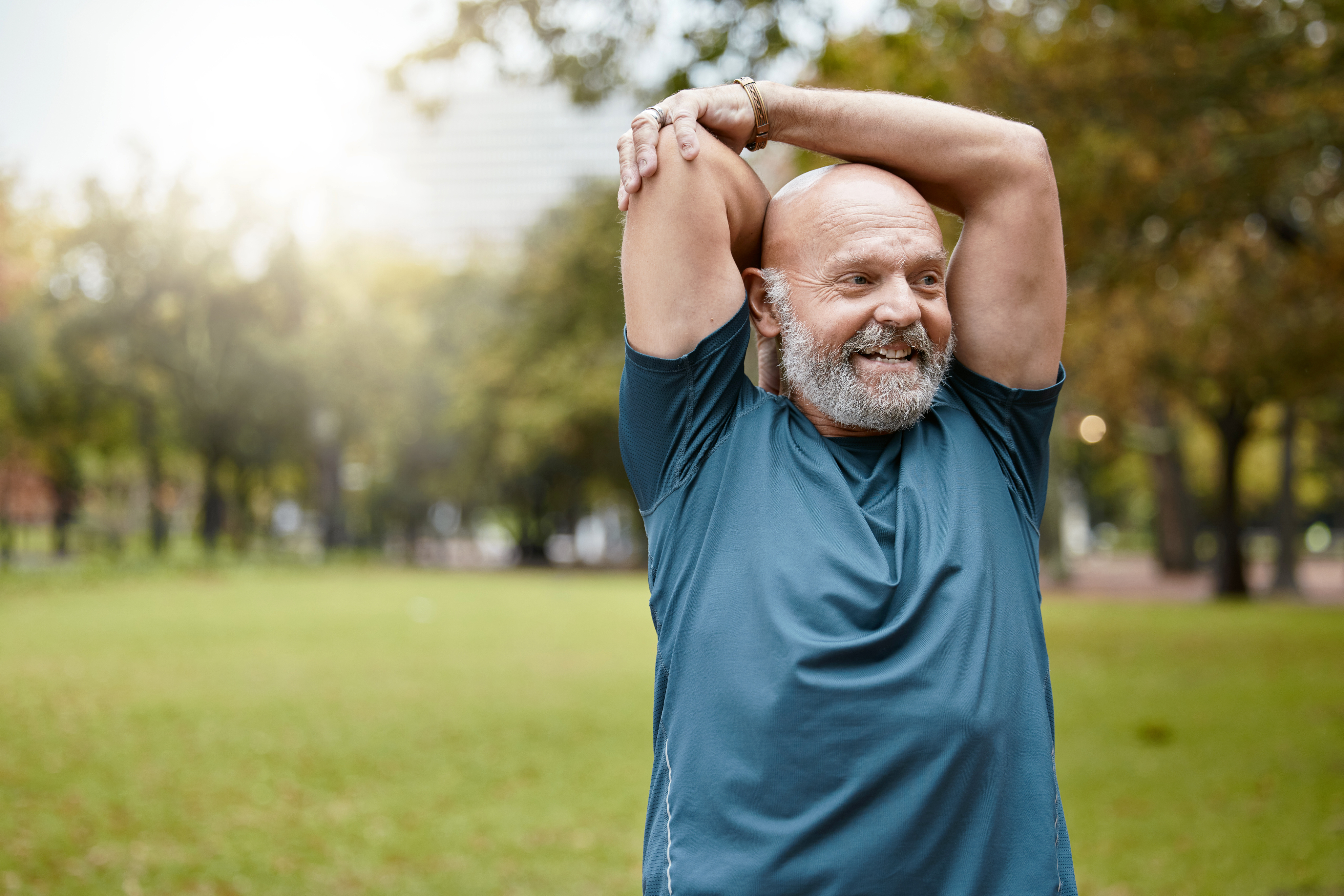 senior male stretching arms outside