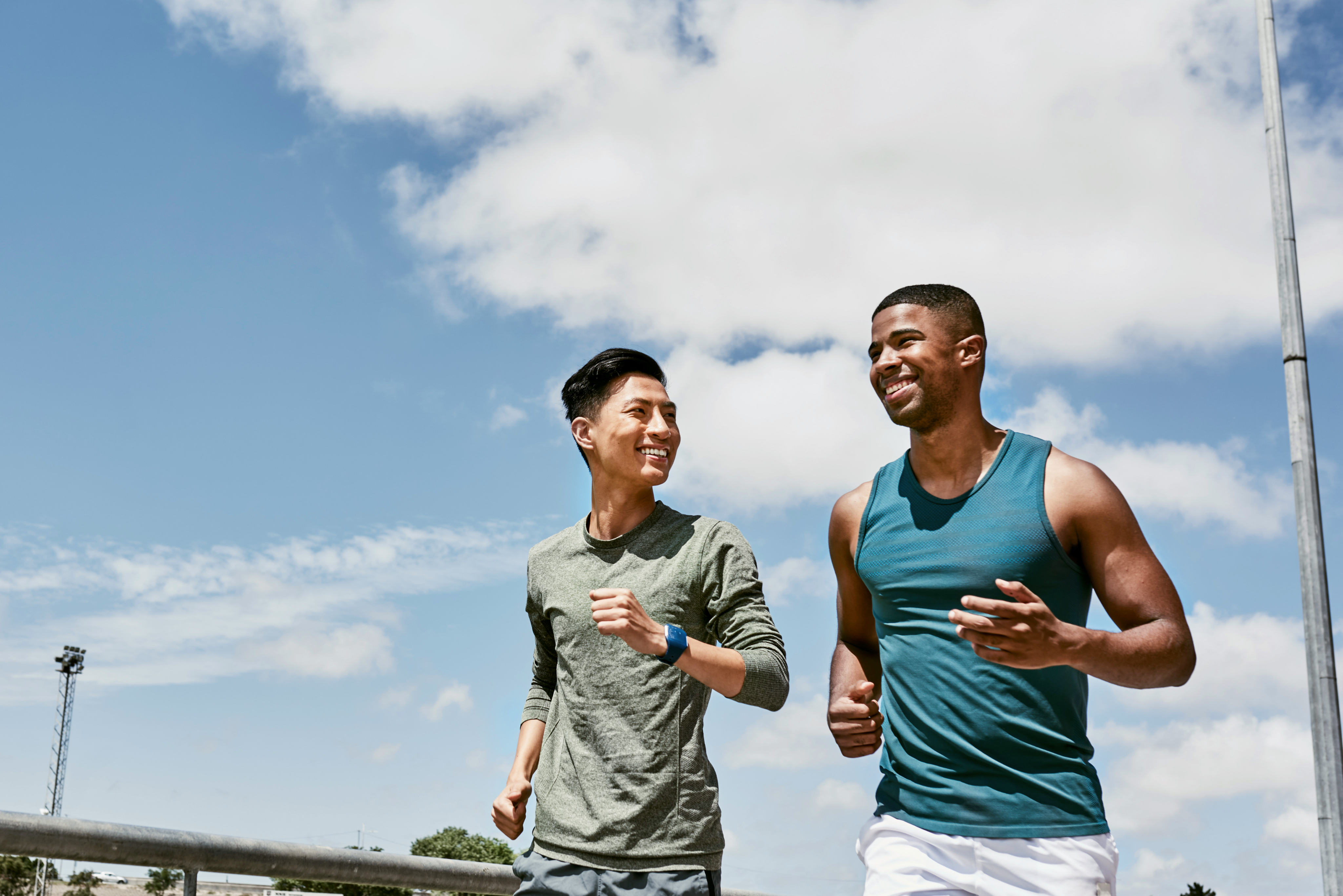 two young men jogging together