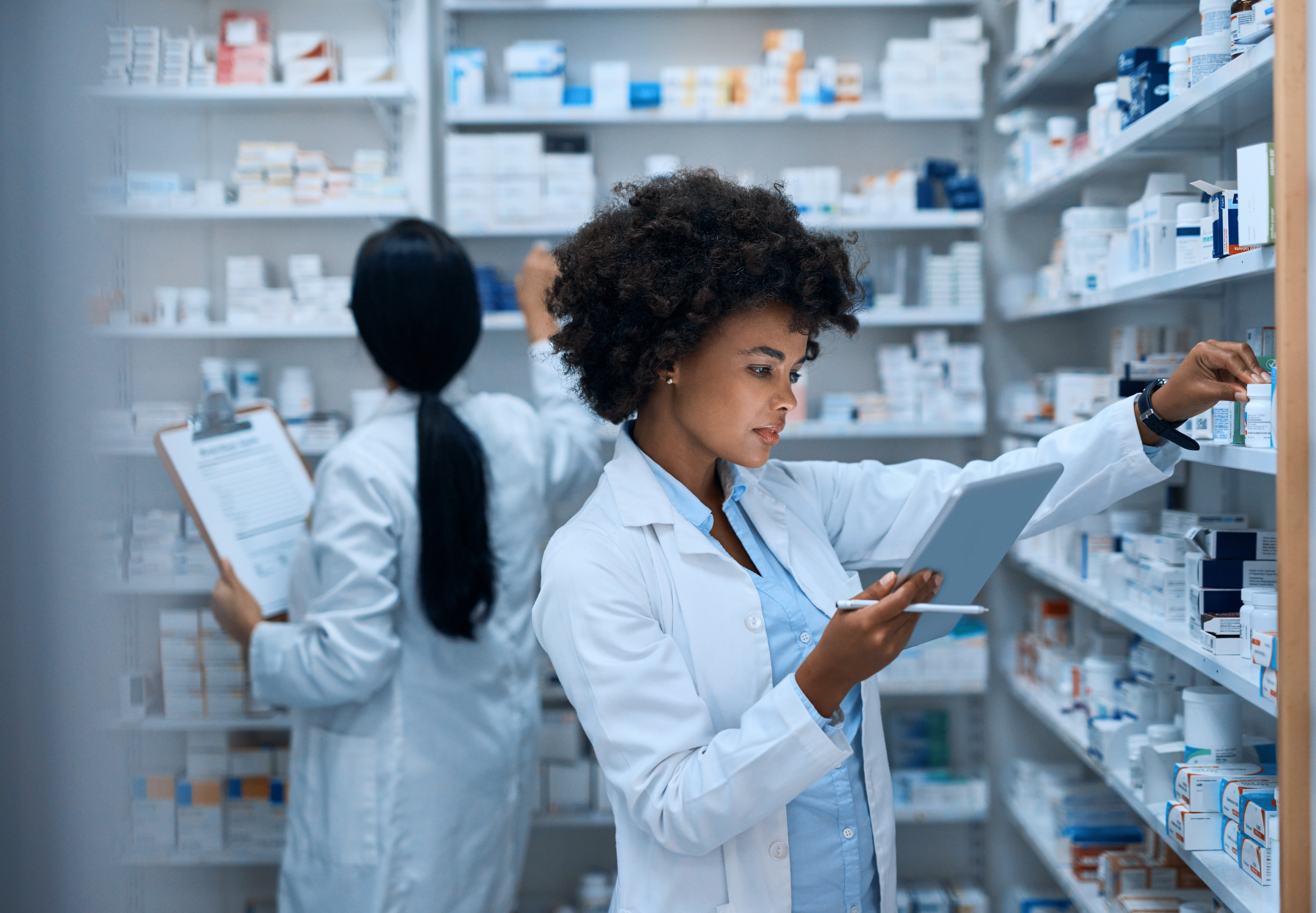 pharmacist with medications and clip board
