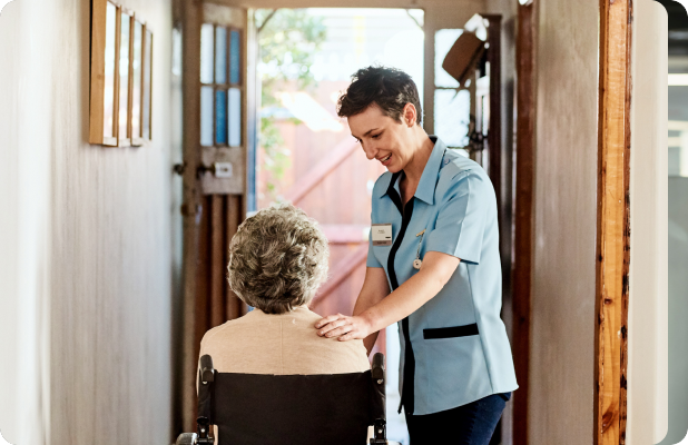 person pushing old woman in wheelchair