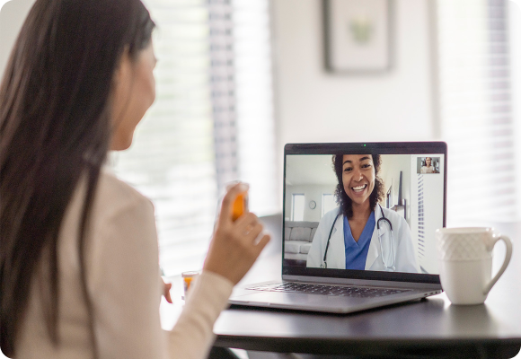 woman holding pill bottle on virtual care call