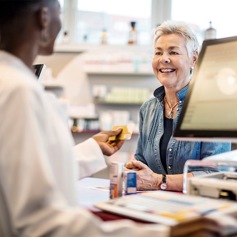 older woman at pharmacy counter