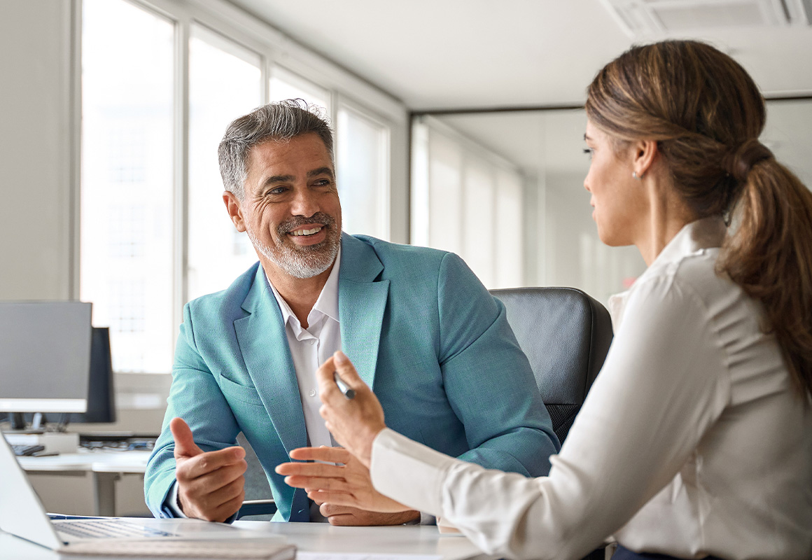 man and woman talking at table