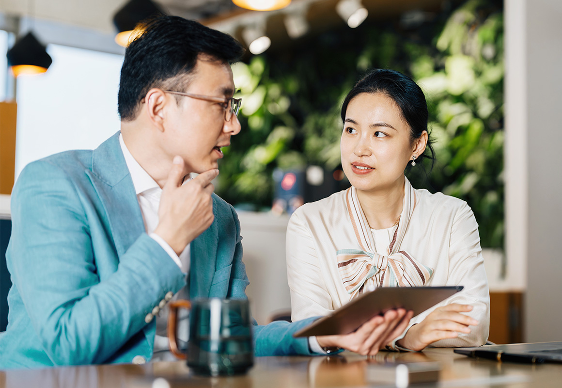 two people chatting at table