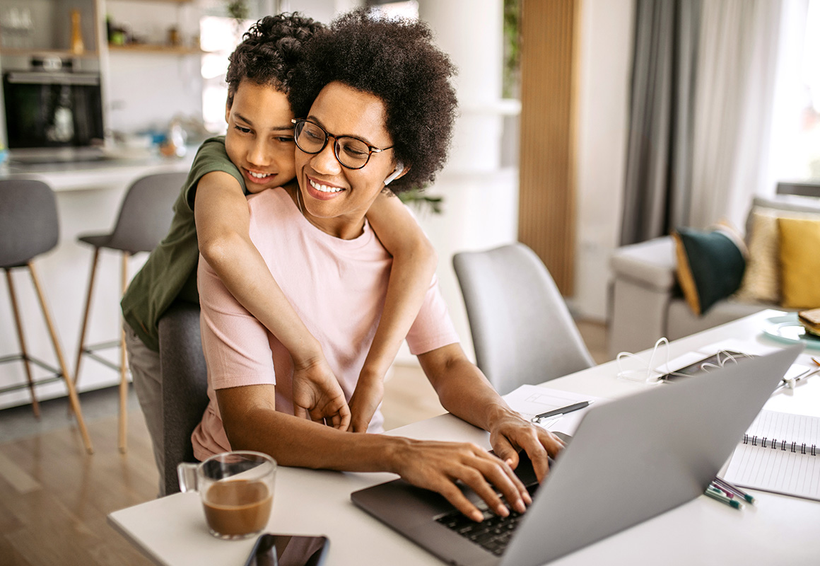 woman and young boy hug at home 