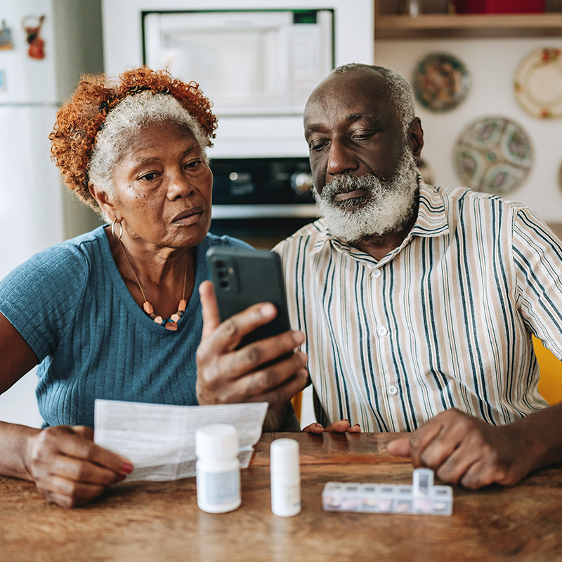 Man and woman on phone with meds