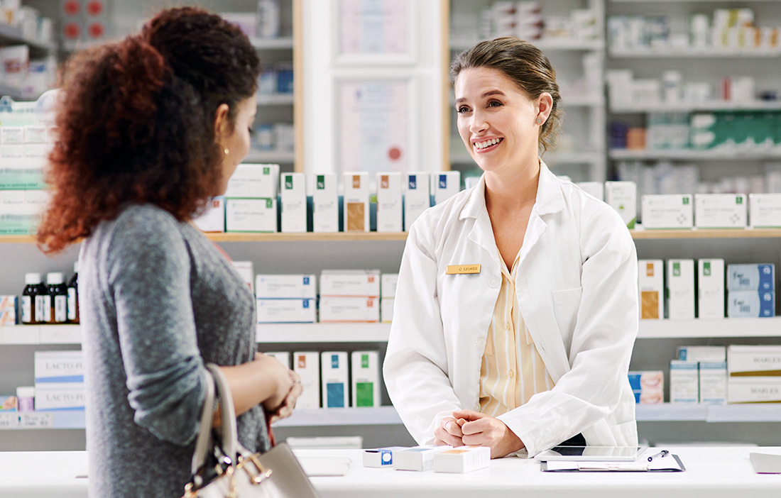 pharmacist helping customer at counter