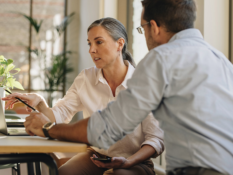 man and woman looking at laptop