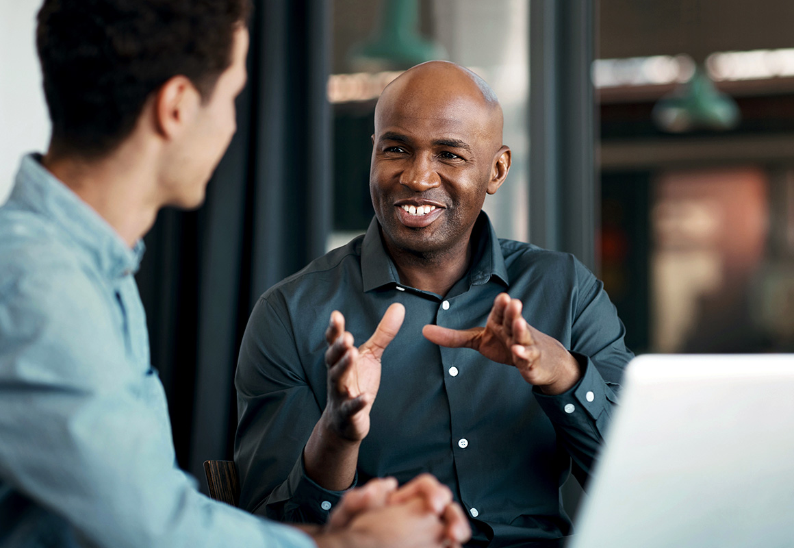 two men at work talking