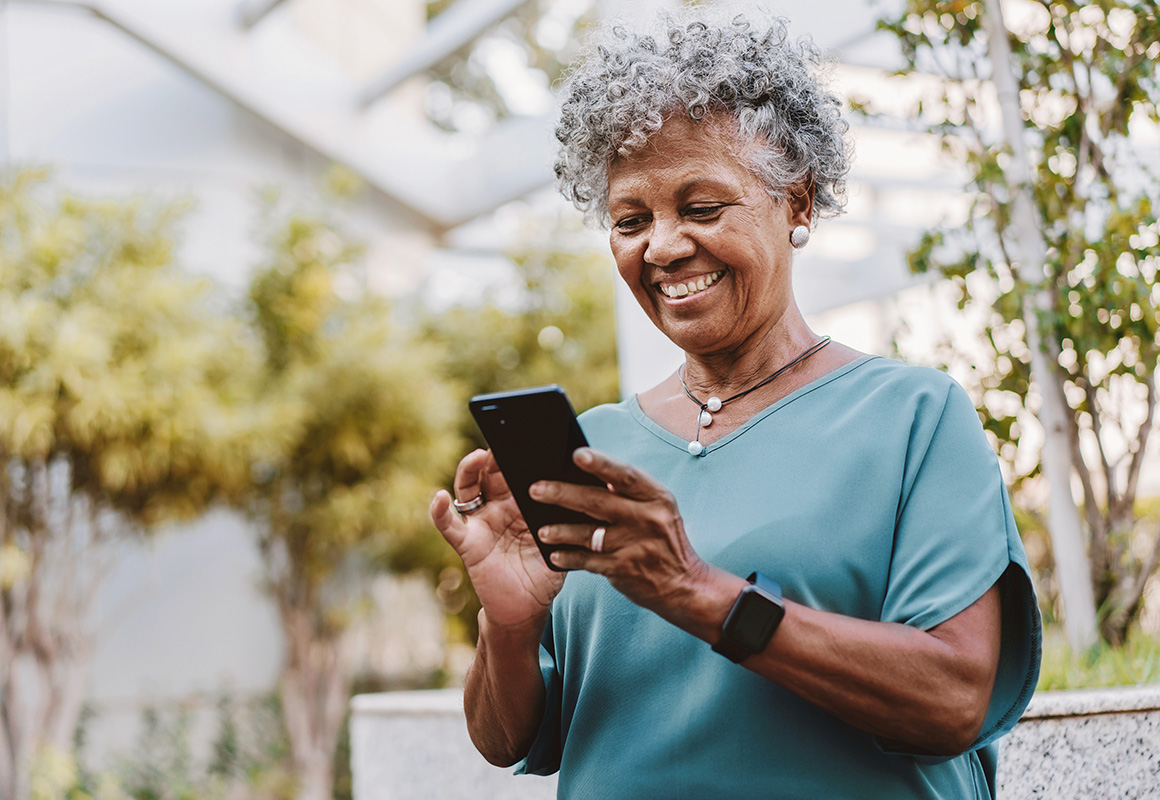 woman smiling outside on phone