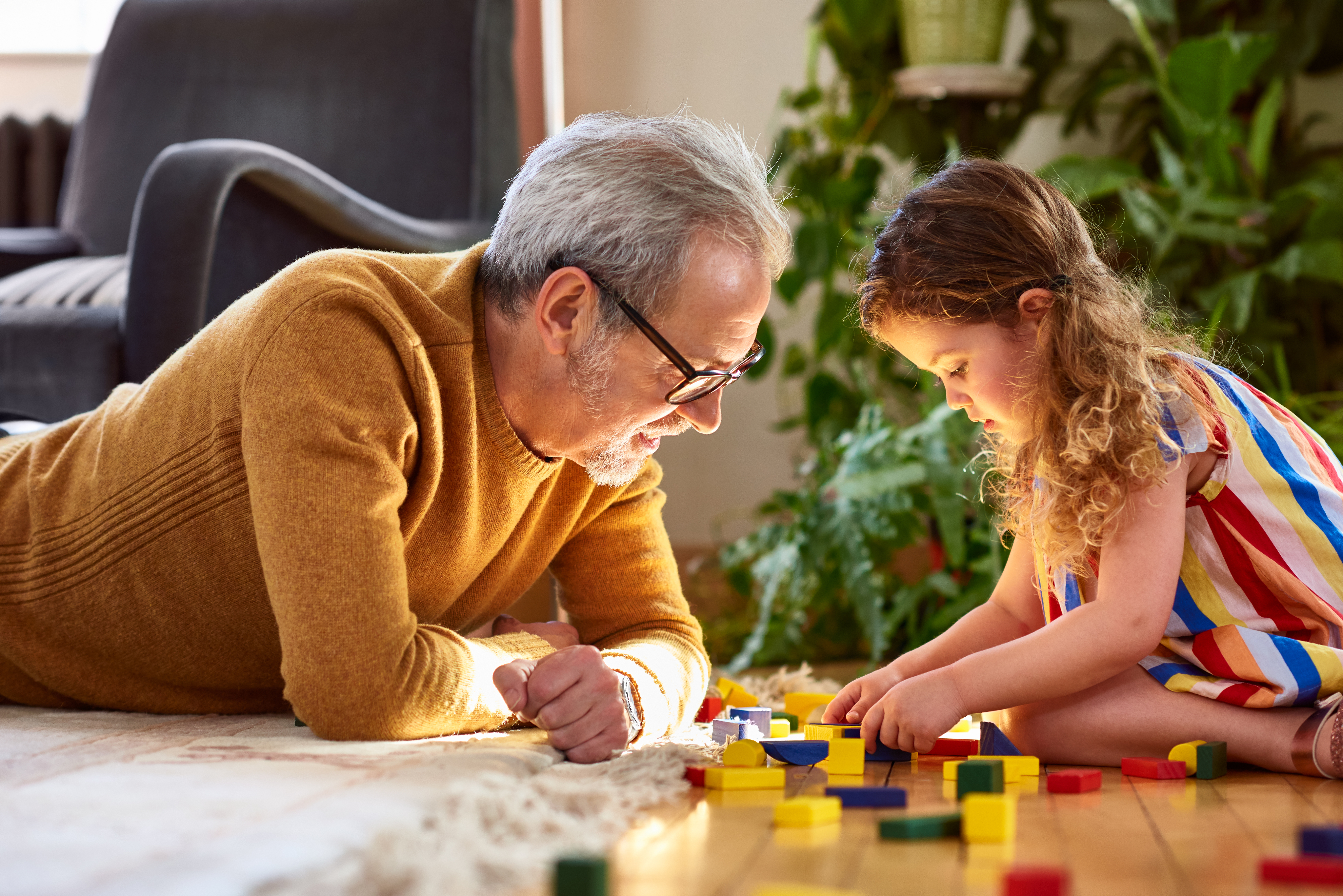 Man and girl playing with toys