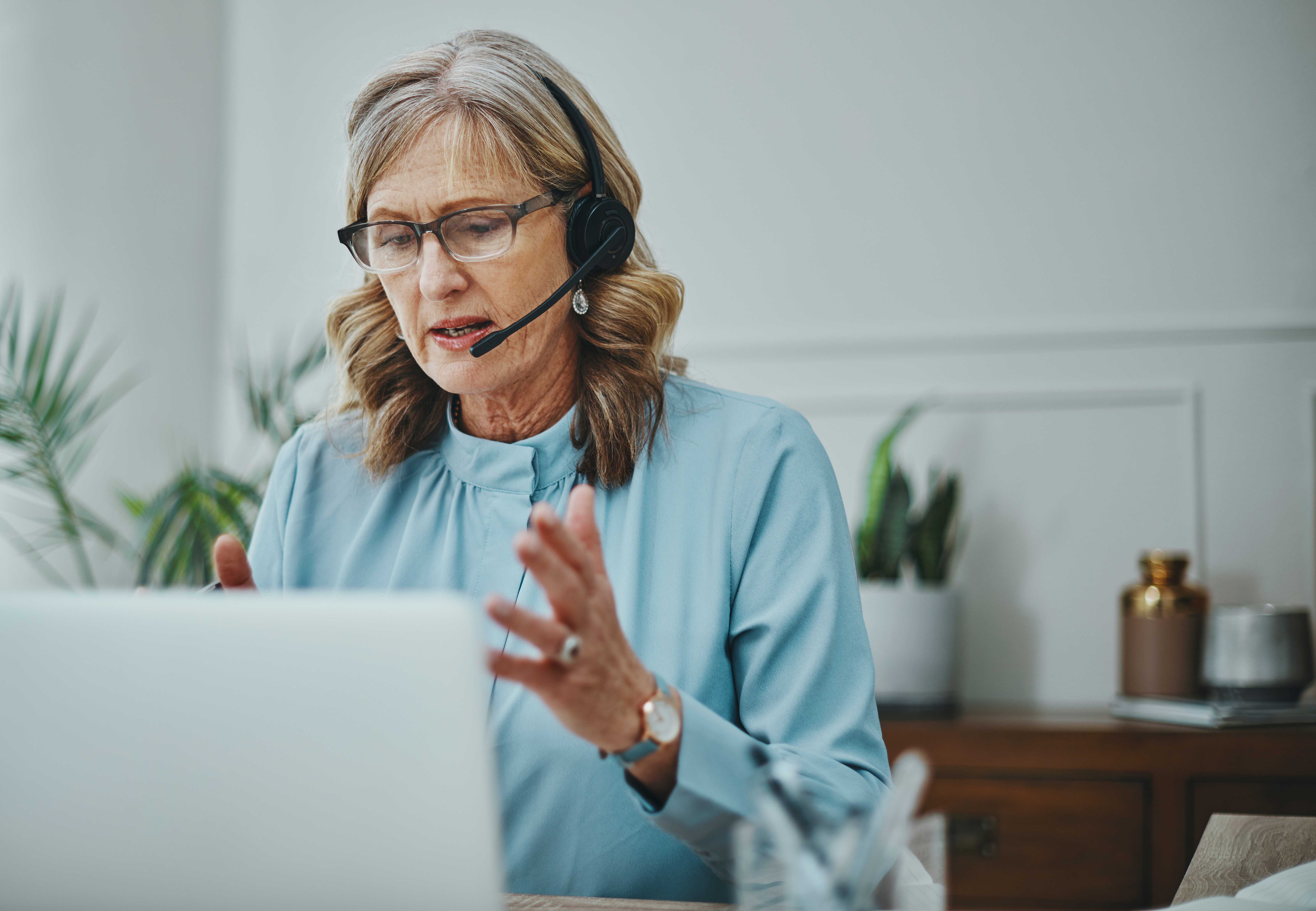 older female employee with headset