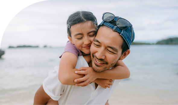 Man and daughter on beach hero