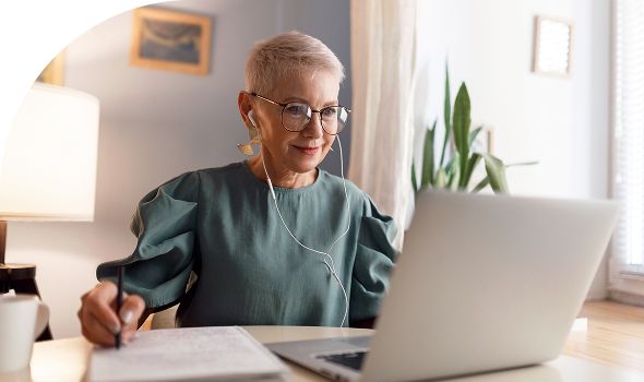 woman at laptop with headphones 