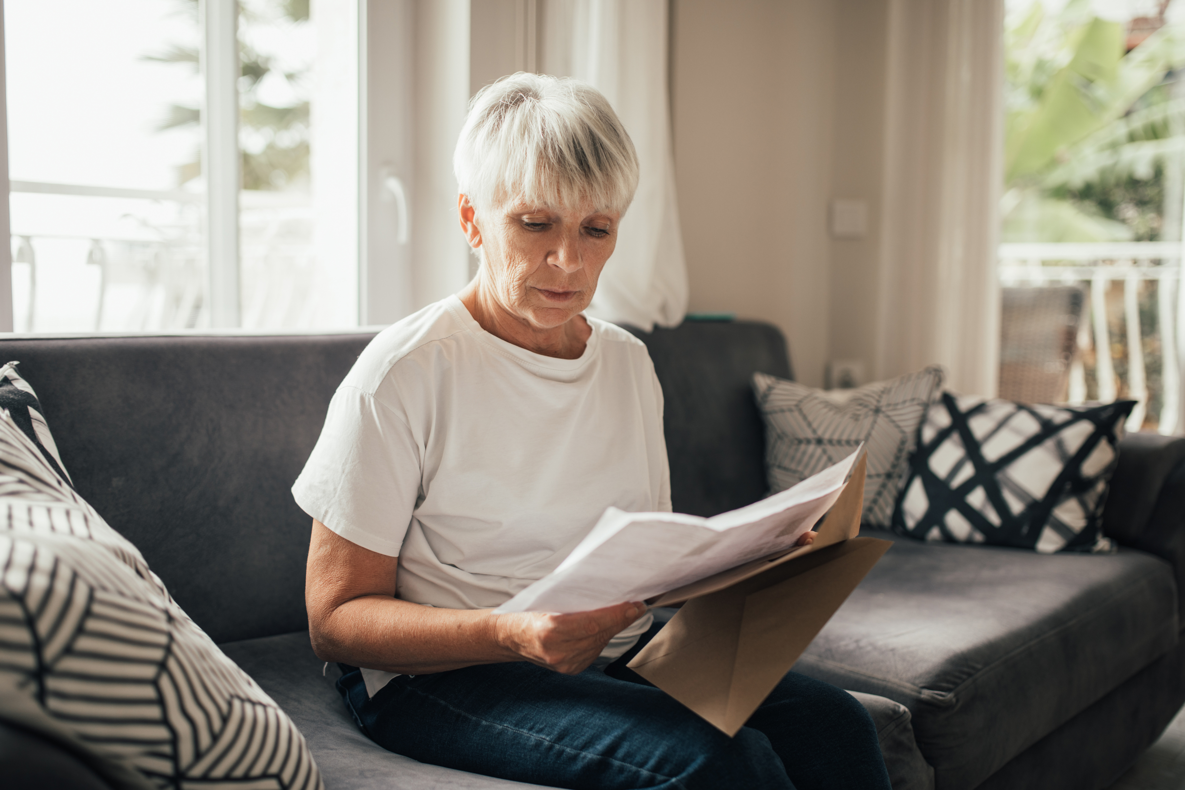 older woman reading letter