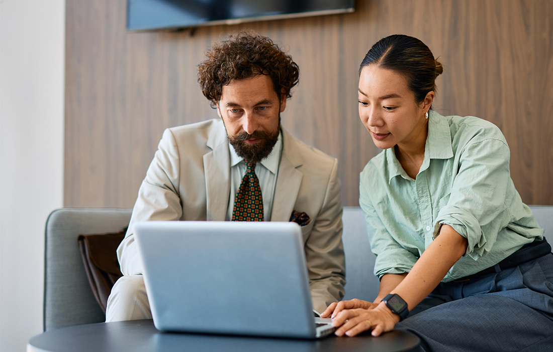 consultants viewing laptop