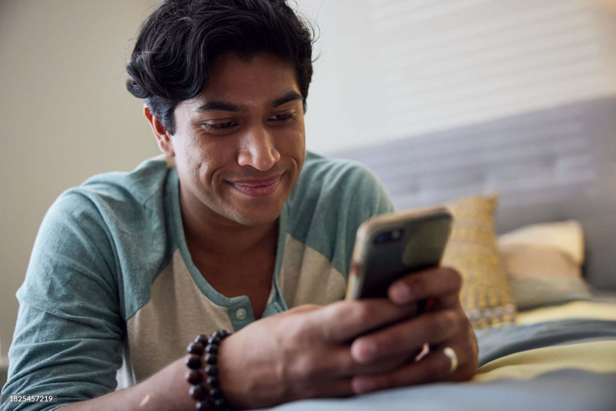 man smiling at phone
