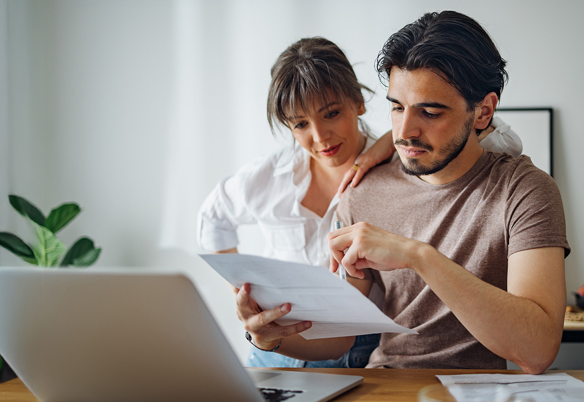 man and woman looking at mail