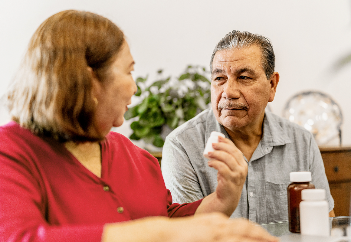 man and woman with pill bottle