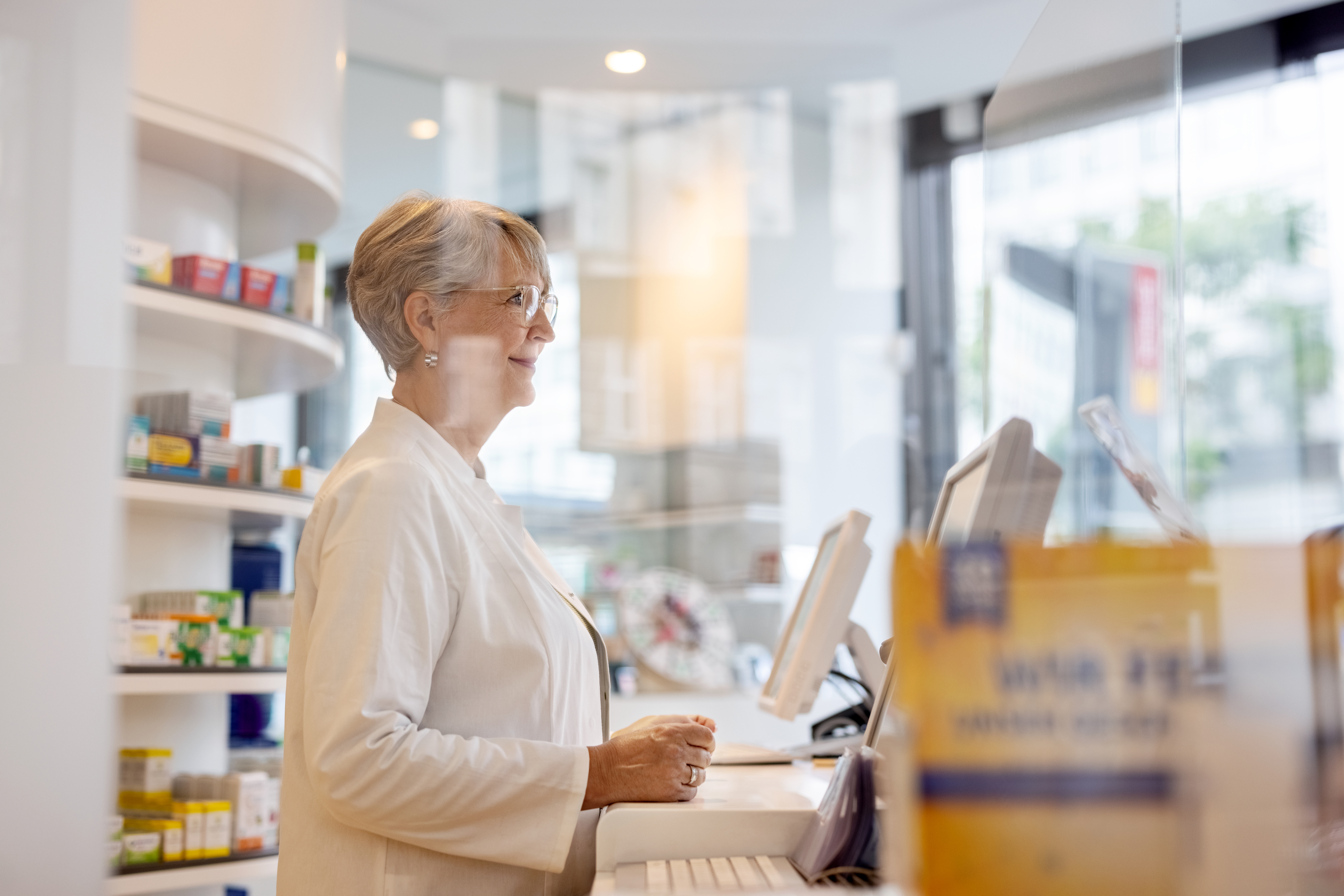 Pharmacist behind counter