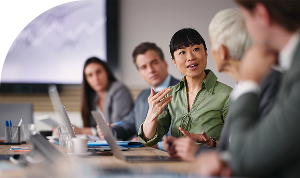 Woman speaking at work meeting hero