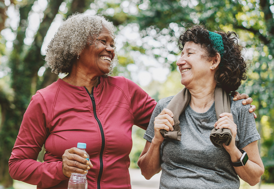 two women smiling while on a walk