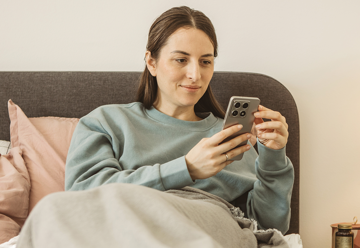 woman smiling at cell phone