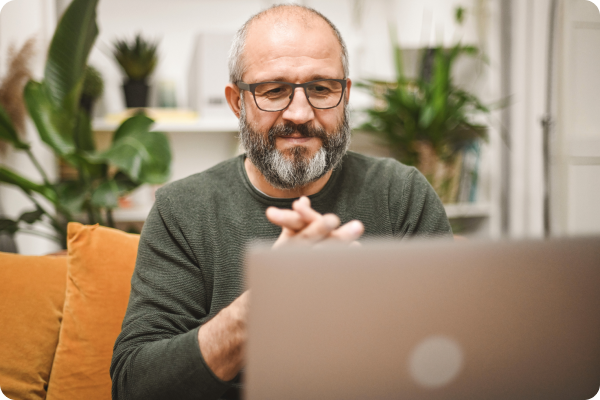 man smiling while on laptop