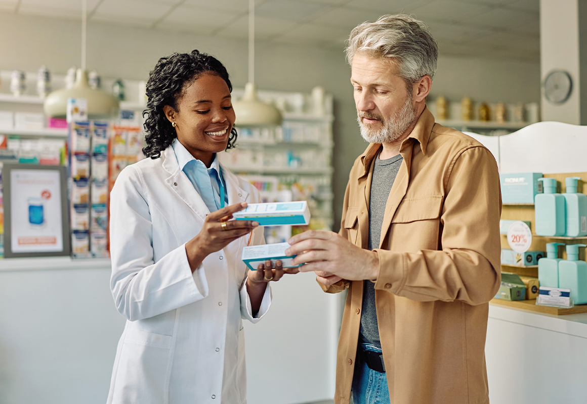 pharmacist giving medication to a patient