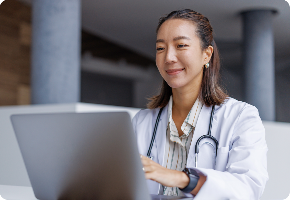 doctor smiling while on laptop